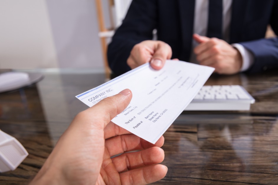 person holding paycheck